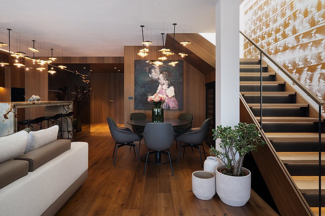 Warm-toned modern interior with statement lighting, dark furniture, and a striking artwork.