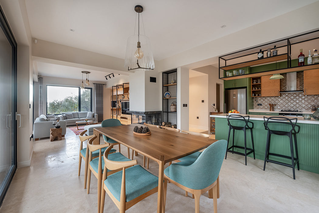 An open-concept kitchen and living room with wooden furniture, green accents, and modern lighting.