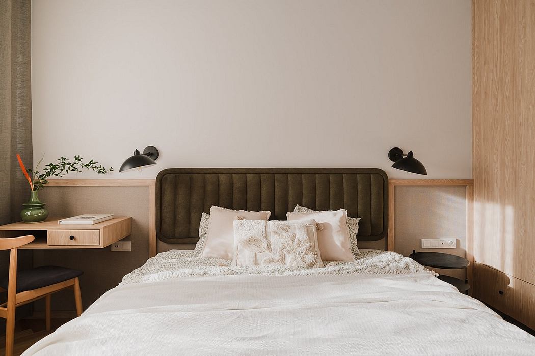 Cozy bedroom with plush headboard, wood accents, and minimalist decor.
