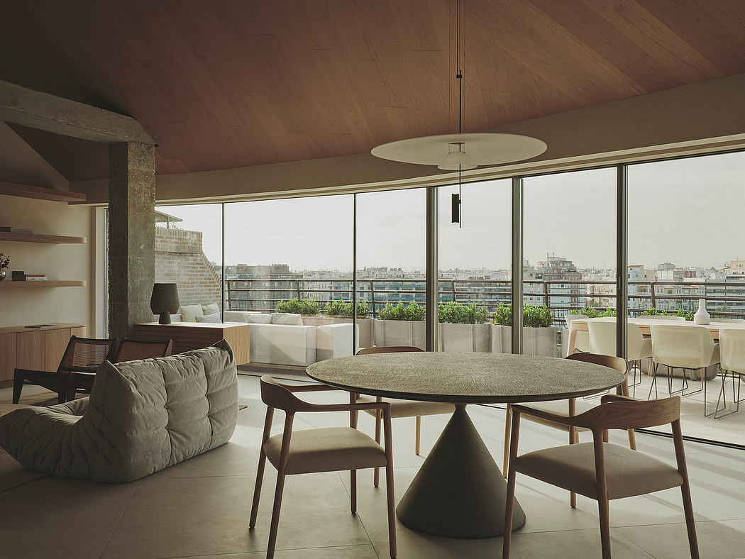 Modern, open-plan living space with panoramic city views, curved furniture, and natural materials.