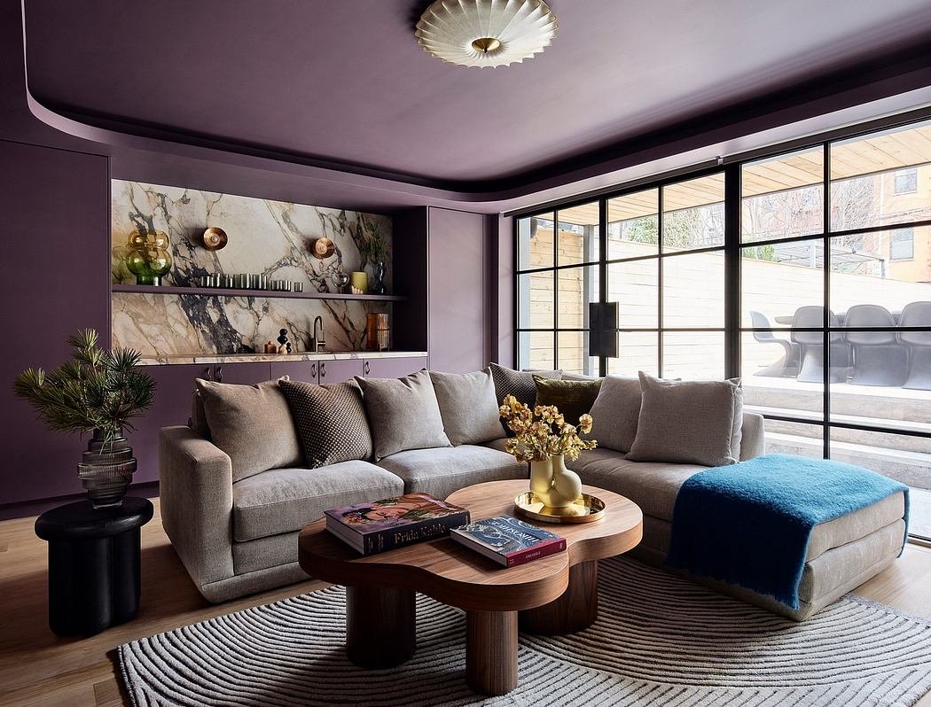 Cozy living room with plush gray sofas, marble shelves, and a striking brass-trimmed light fixture.