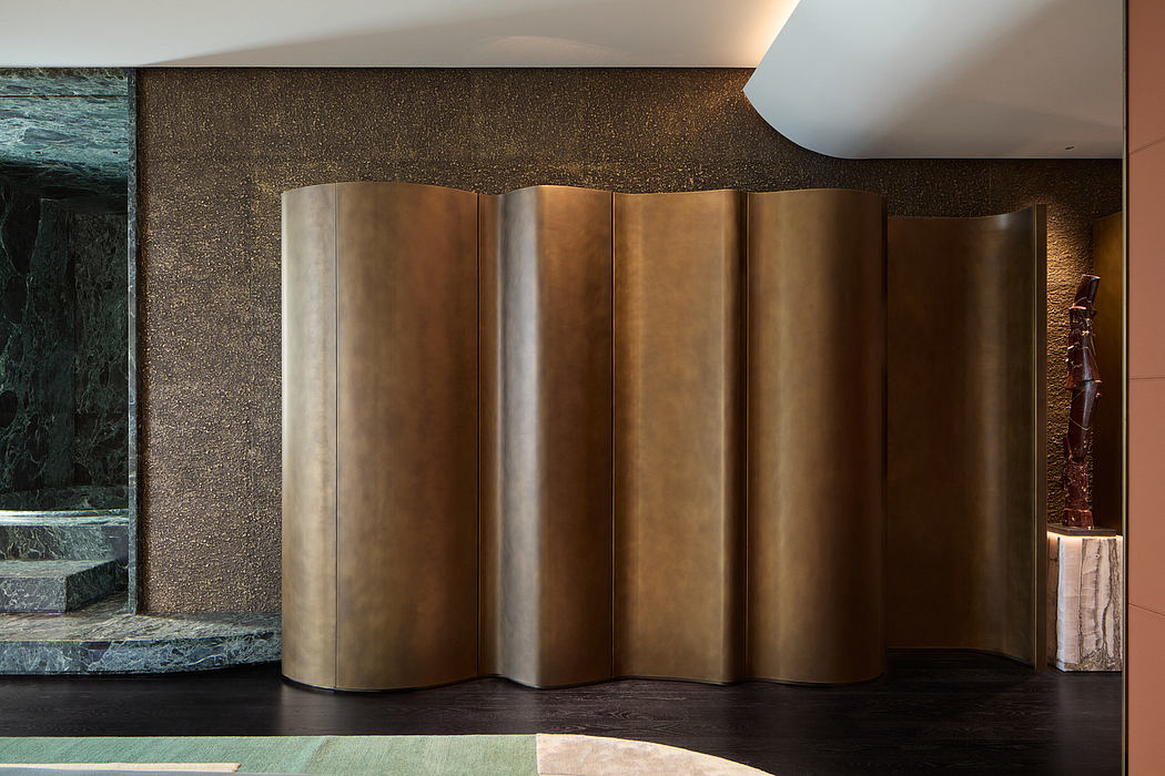 Ornate bronze panels with undulating curves accentuate the dramatic space.
