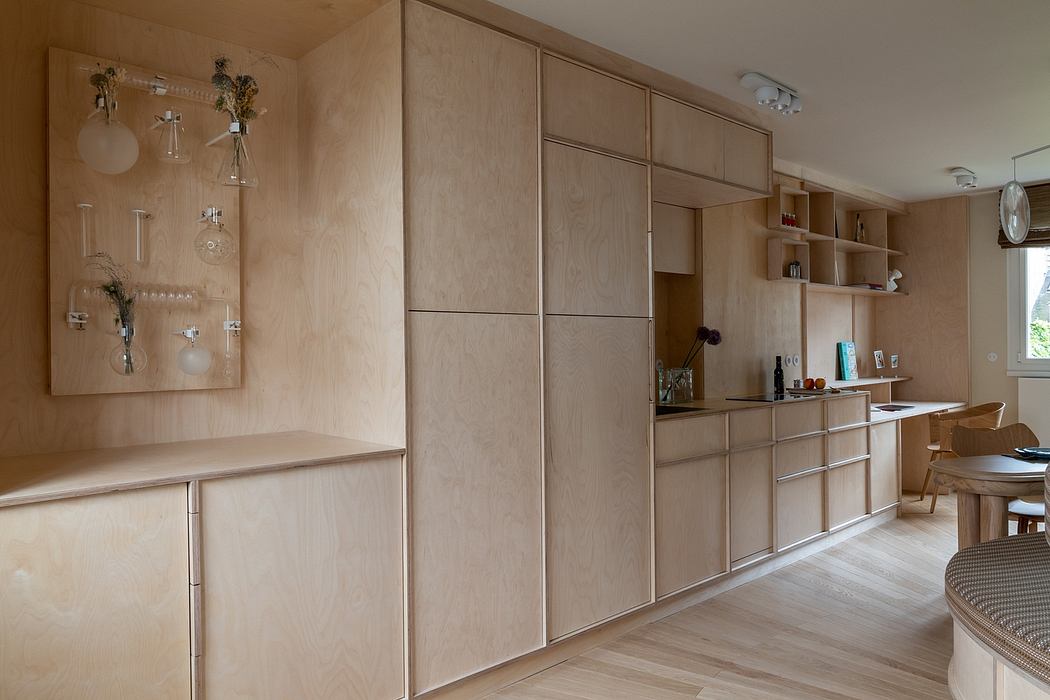Warm-toned wood cabinetry and shelving create a cozy, minimalist kitchen design.