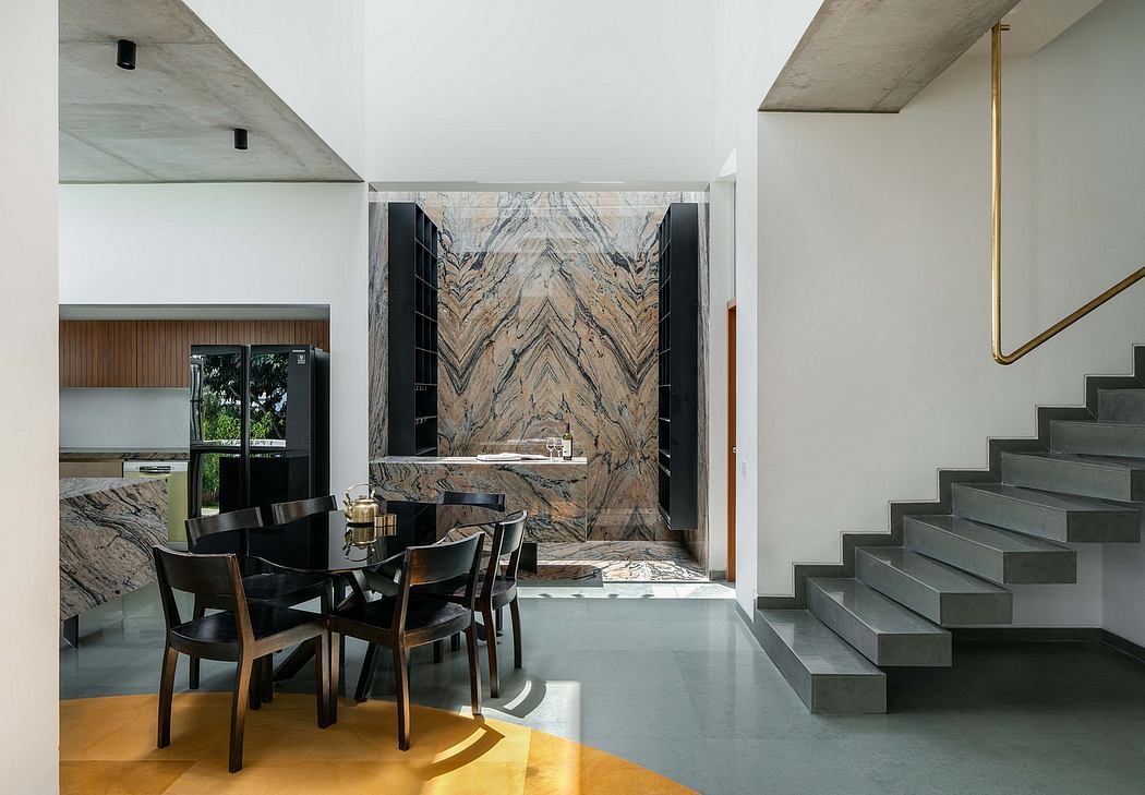 Striking marble accent wall and concrete staircase in modern, minimalist interior.