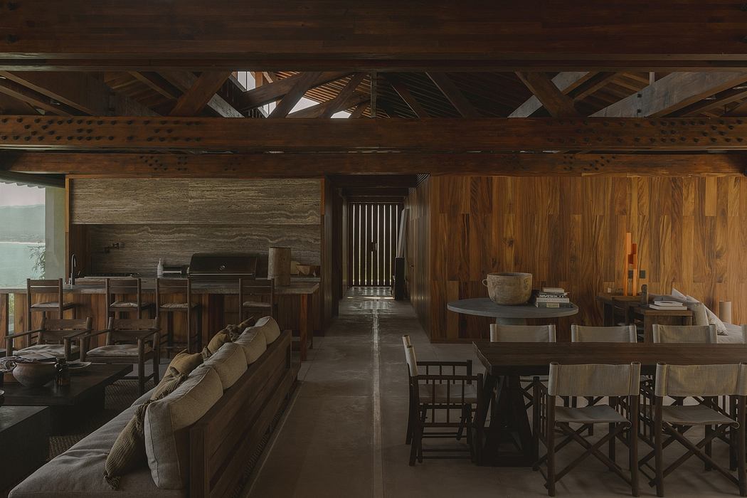 A rustic wooden interior with exposed beams, furniture, and a cozy seating area.