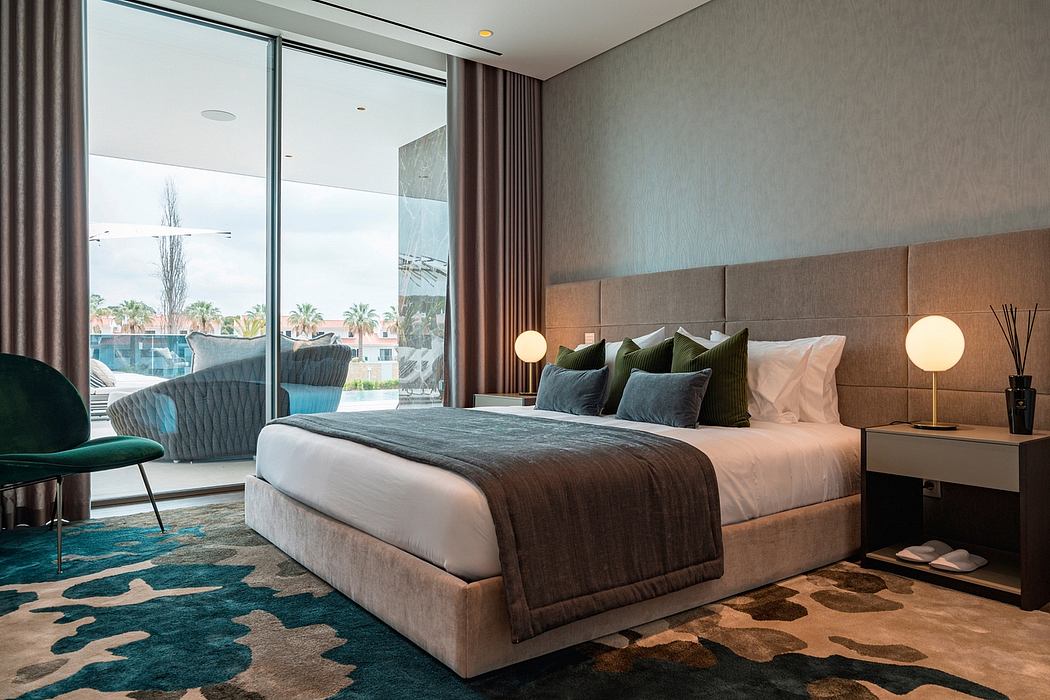 Modern, stylish bedroom with floor-to-ceiling windows, plush bedding, and a bold area rug.