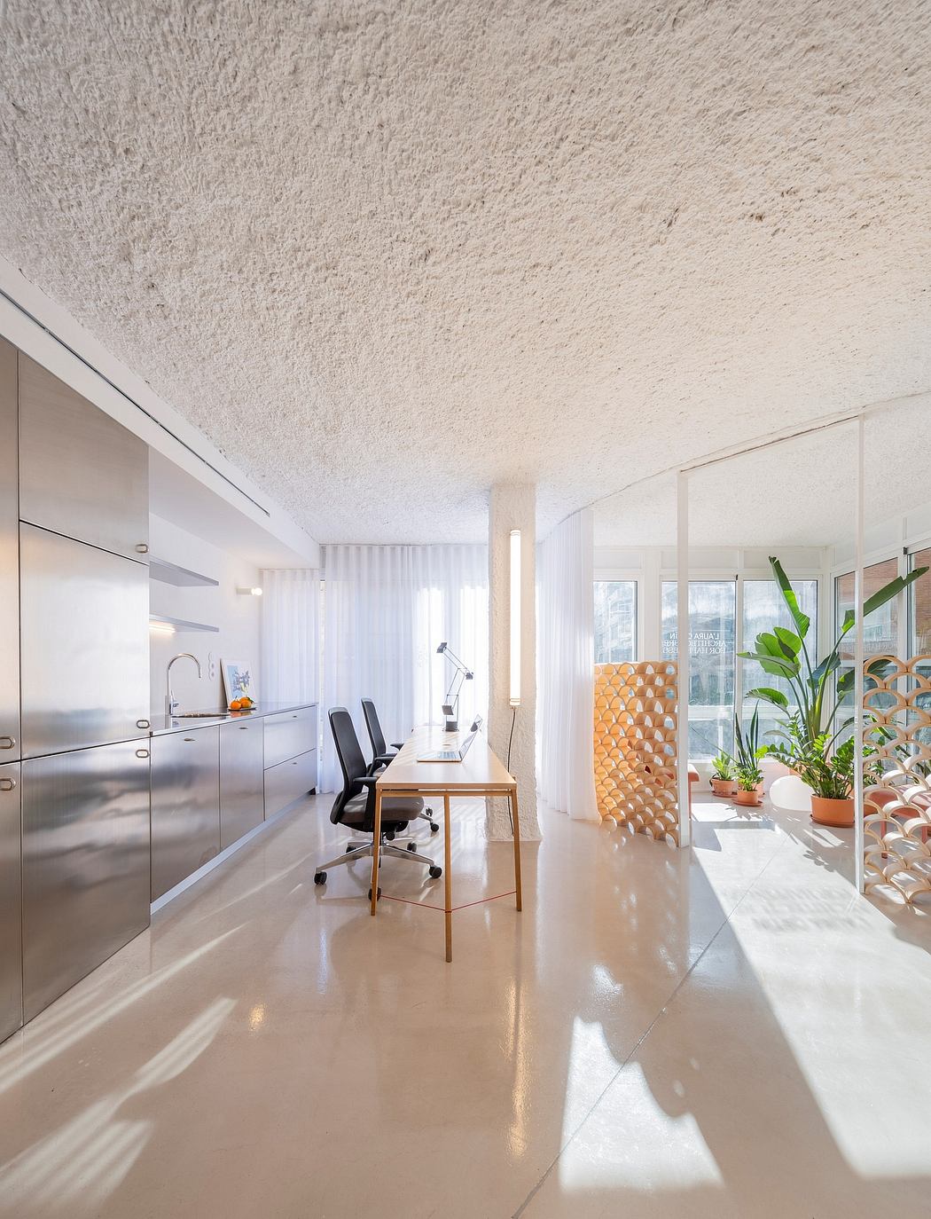 Sleek, minimalist office space with modern furnishings and natural light filtering in.