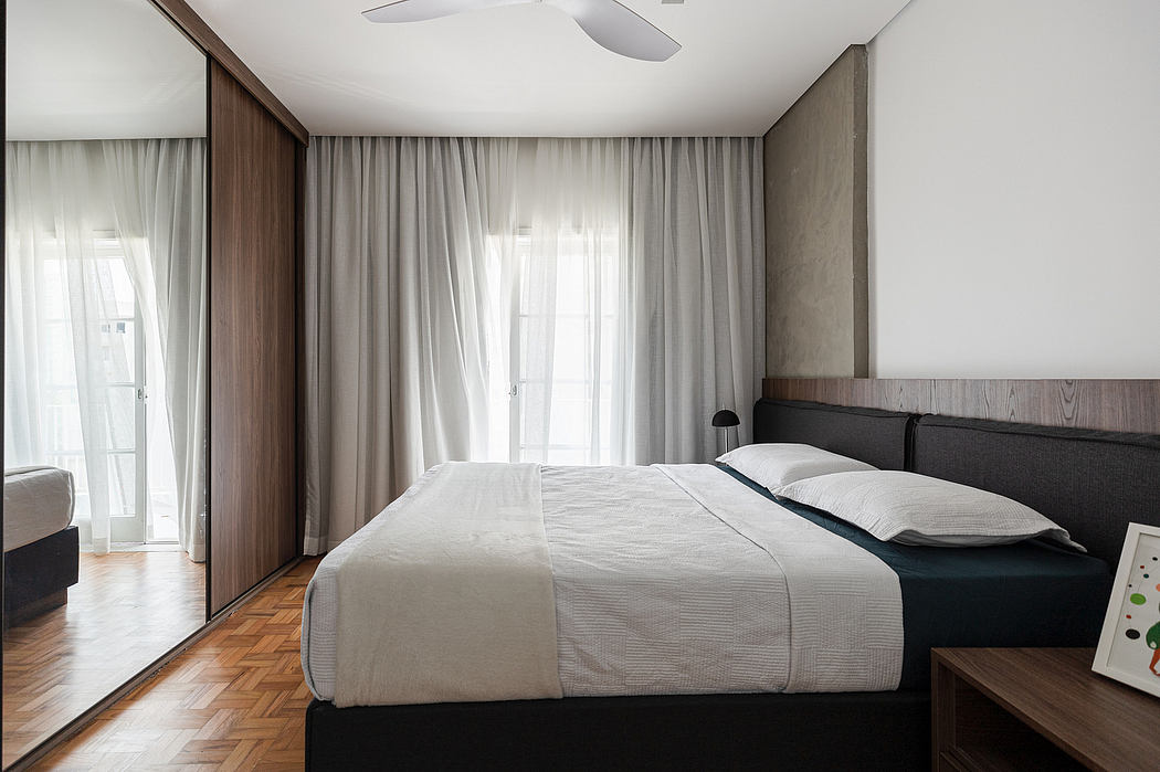 A modern bedroom with wooden accents, large windows, and a sleek, minimalist design.
