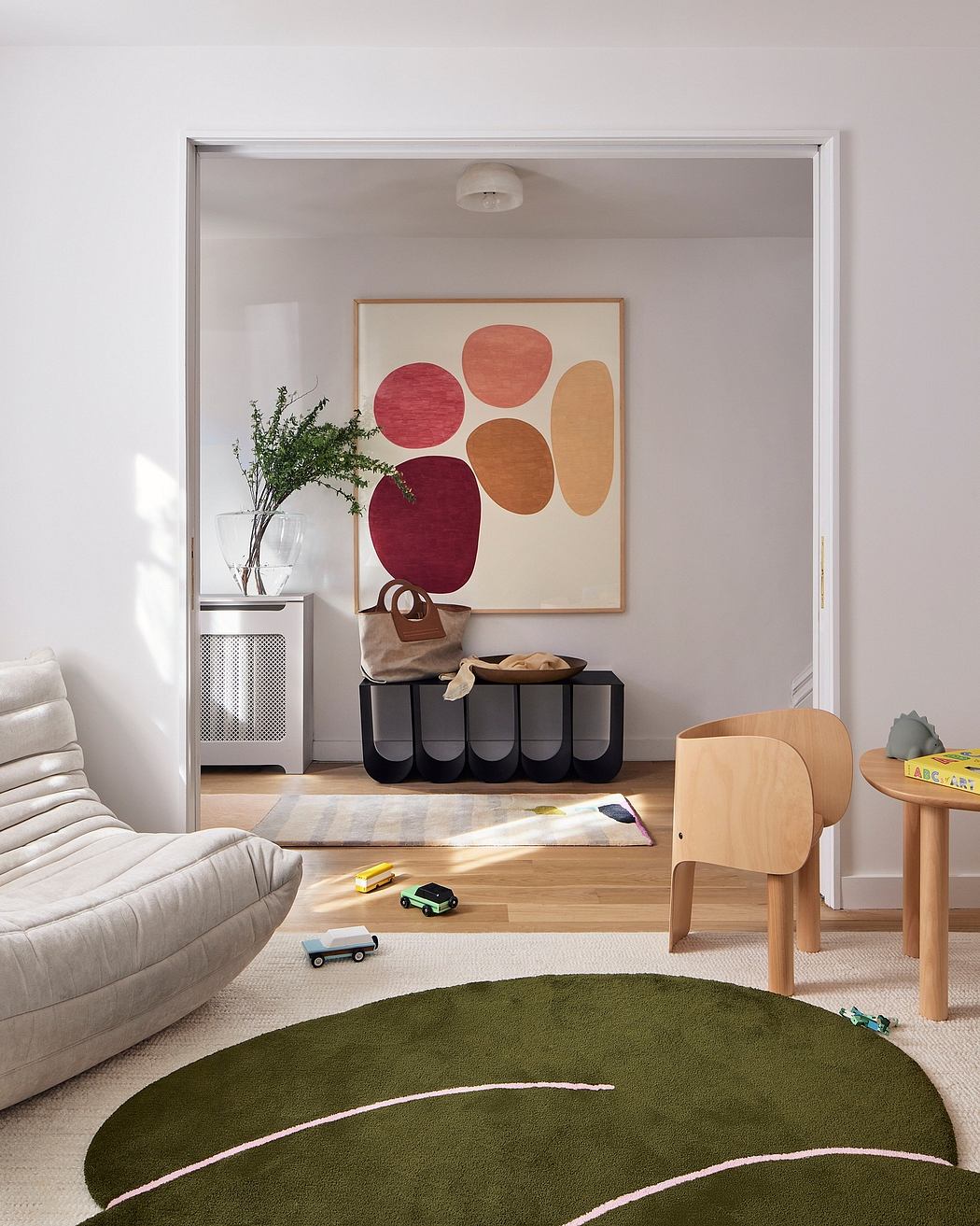 Welcoming modern interior with abstract art, minimalist furniture, and playful decor elements.