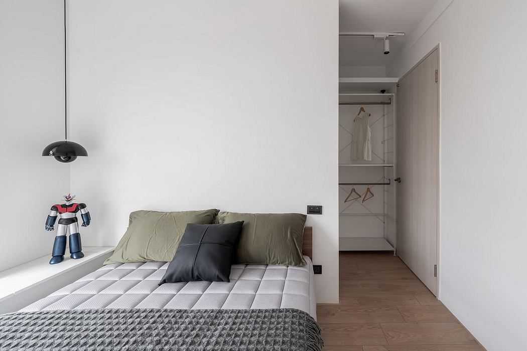 A minimalist bedroom with a modern, built-in closet and a simple, patterned bedding set.
