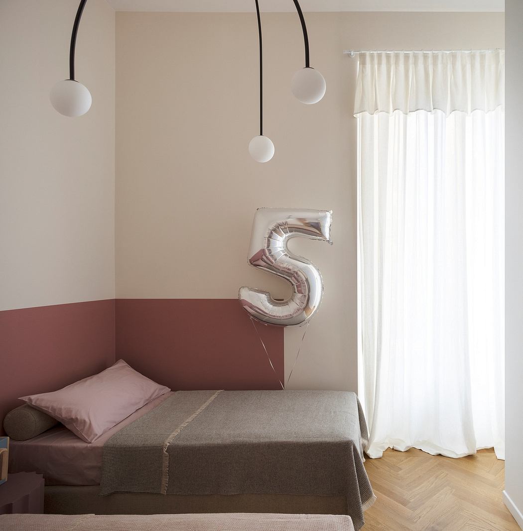 Minimalist bedroom with pendant lights, white curtains, and a number 5 balloon.
