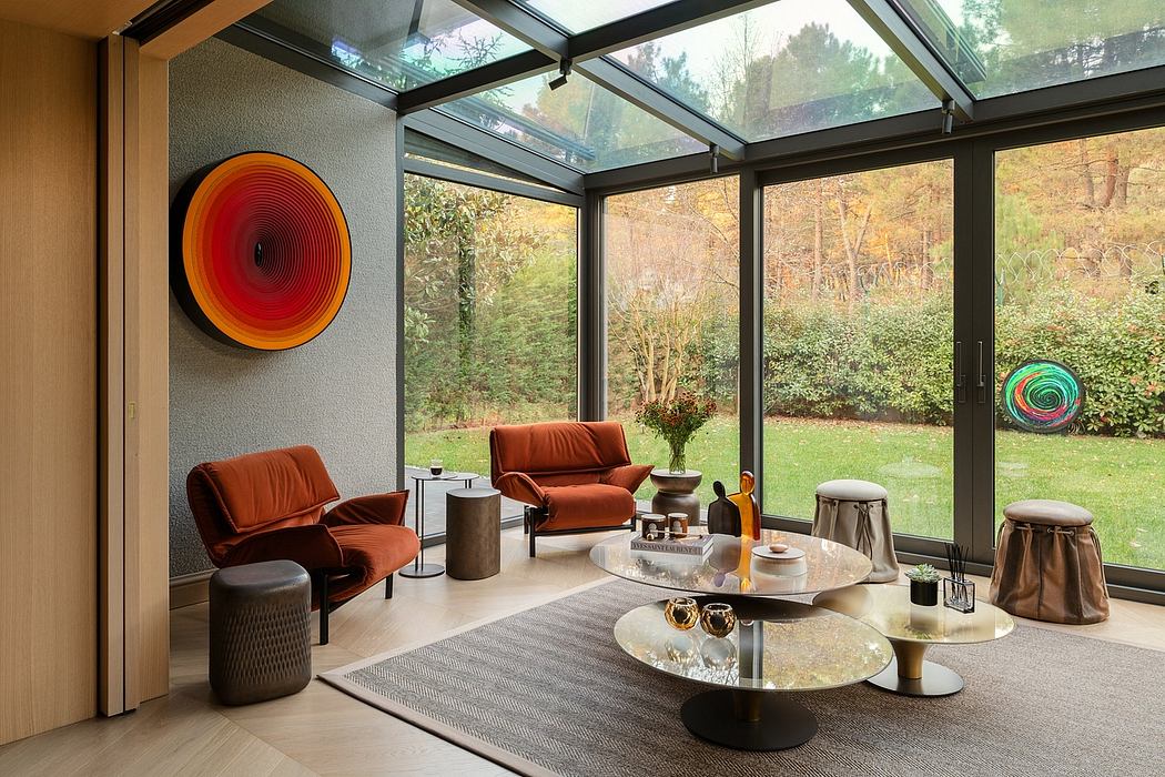Expansive glass walls offer views of lush greenery, complemented by vibrant artwork.