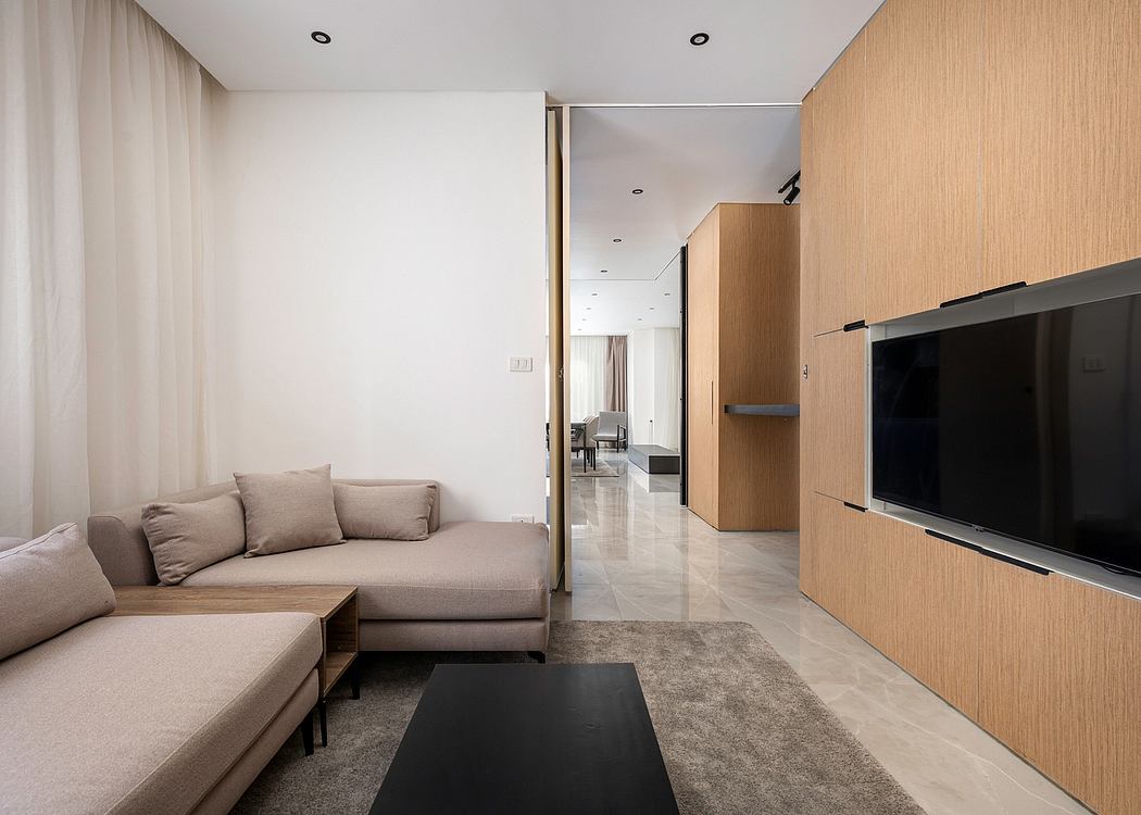 Modern minimalist living room with neutral tones, sleek furniture, and recessed lighting.