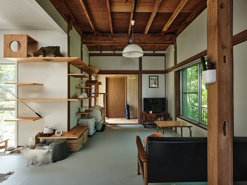 Rustic wooden beams, minimalist furnishings, and natural light create a cozy, Japanese-inspired space.
