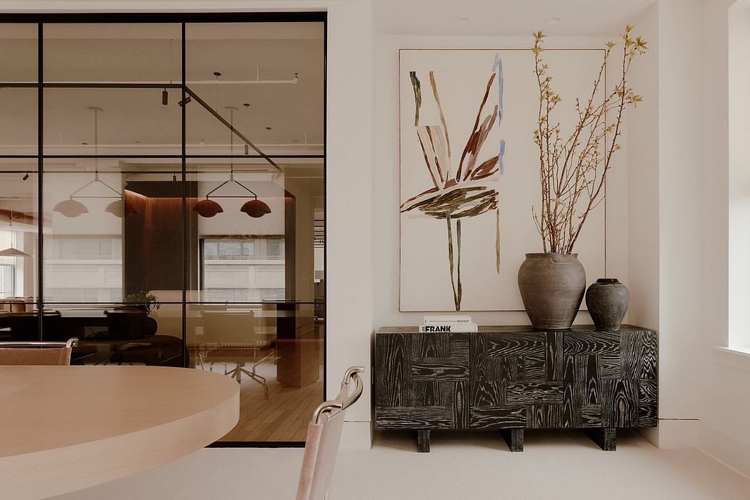Elegant modern office with sleek glass walls, abstract artwork, and rustic wood furniture.