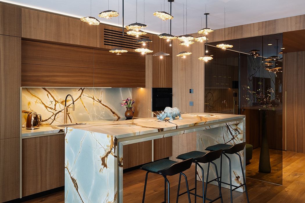 Luxurious kitchen with ornate lighting fixtures, wooden cabinetry, and marble countertops.