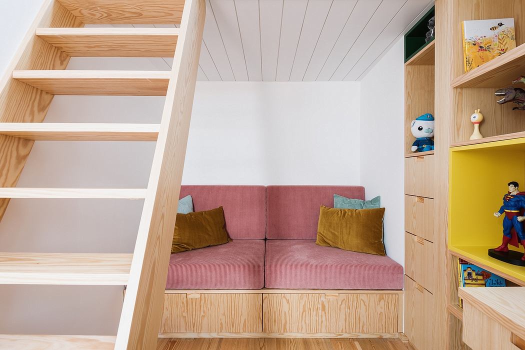 Cozy wood-lined room with a pink sofa, shelves, and toys, offering a warm, playful ambiance.