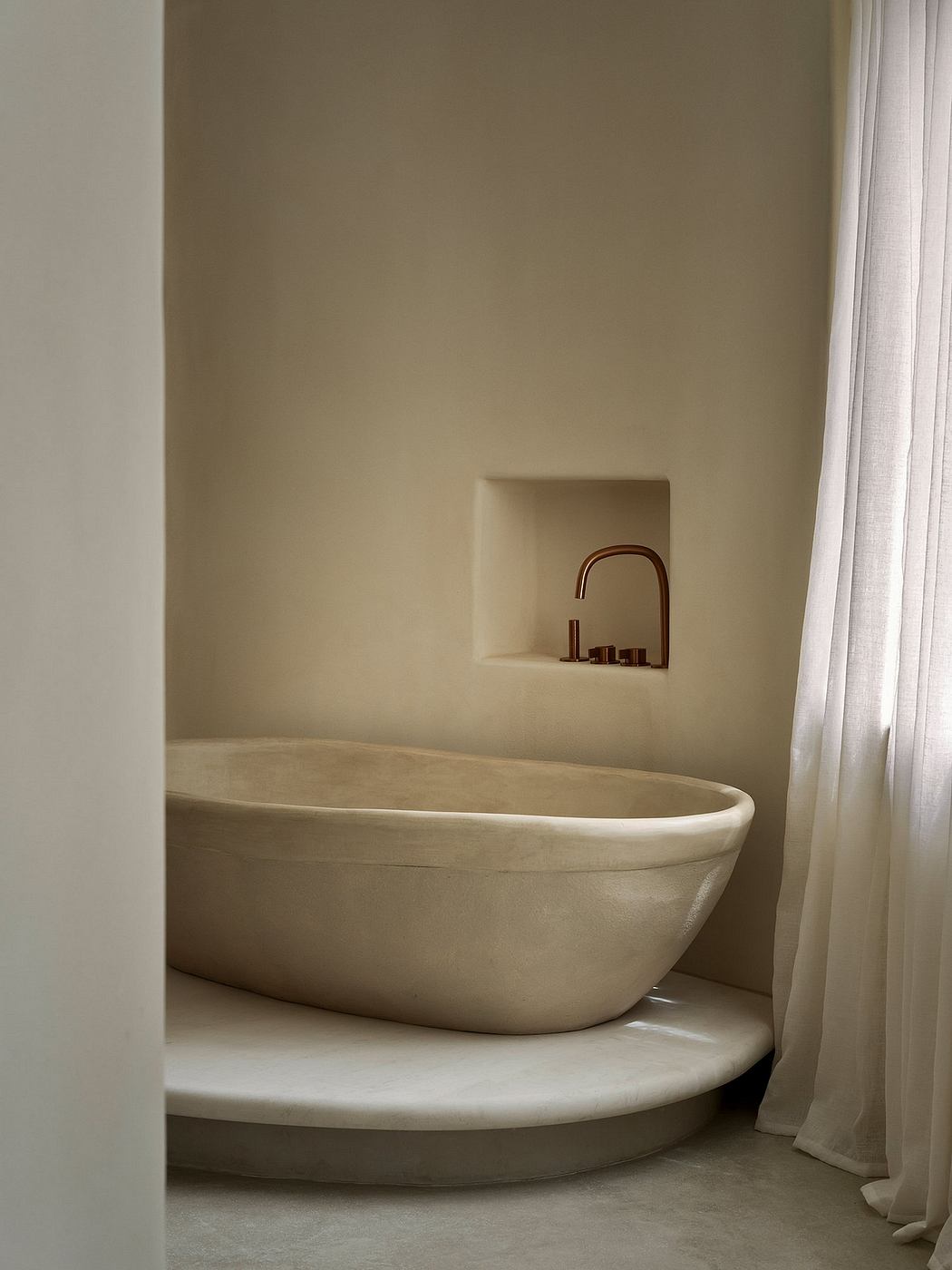 Elegant bathtub nook with minimalist faucet and warm, earthy tones.