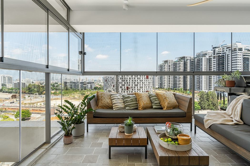 Sleek glass walls frame a modern living space with plush seating and cityscape view.