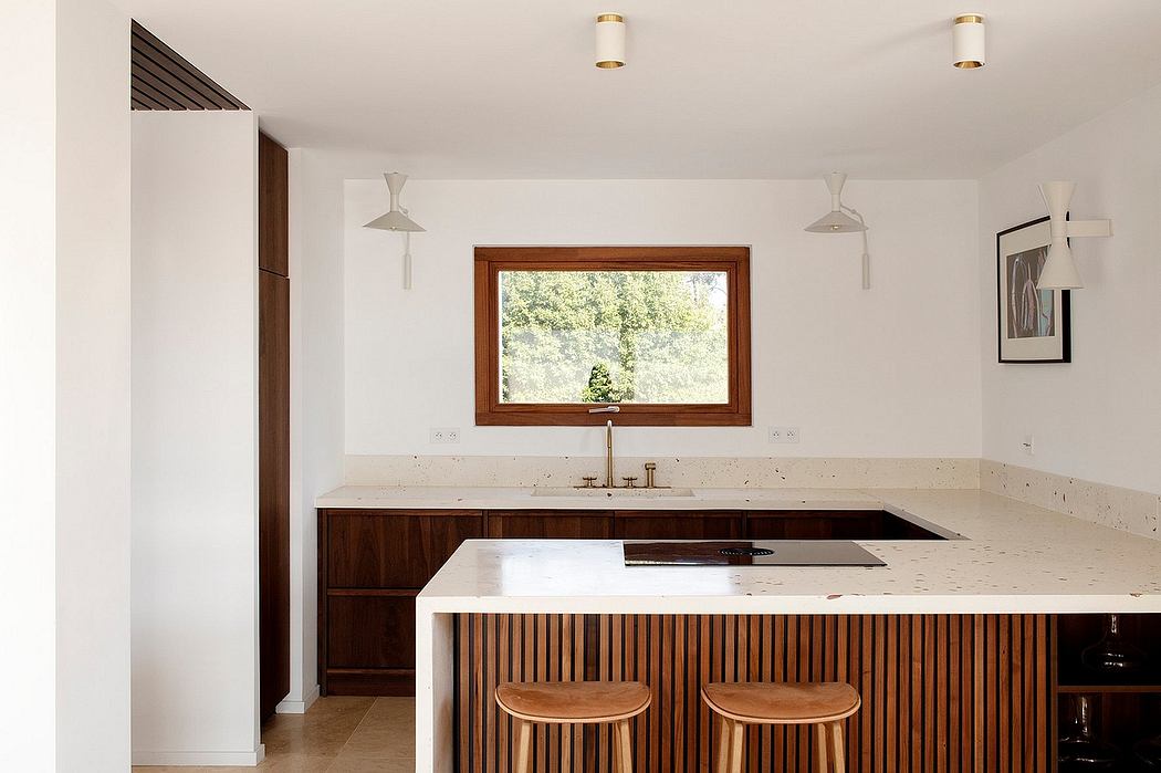 Well-designed kitchen with wooden accents, built-in cabinetry, and a large window overlooking nature.