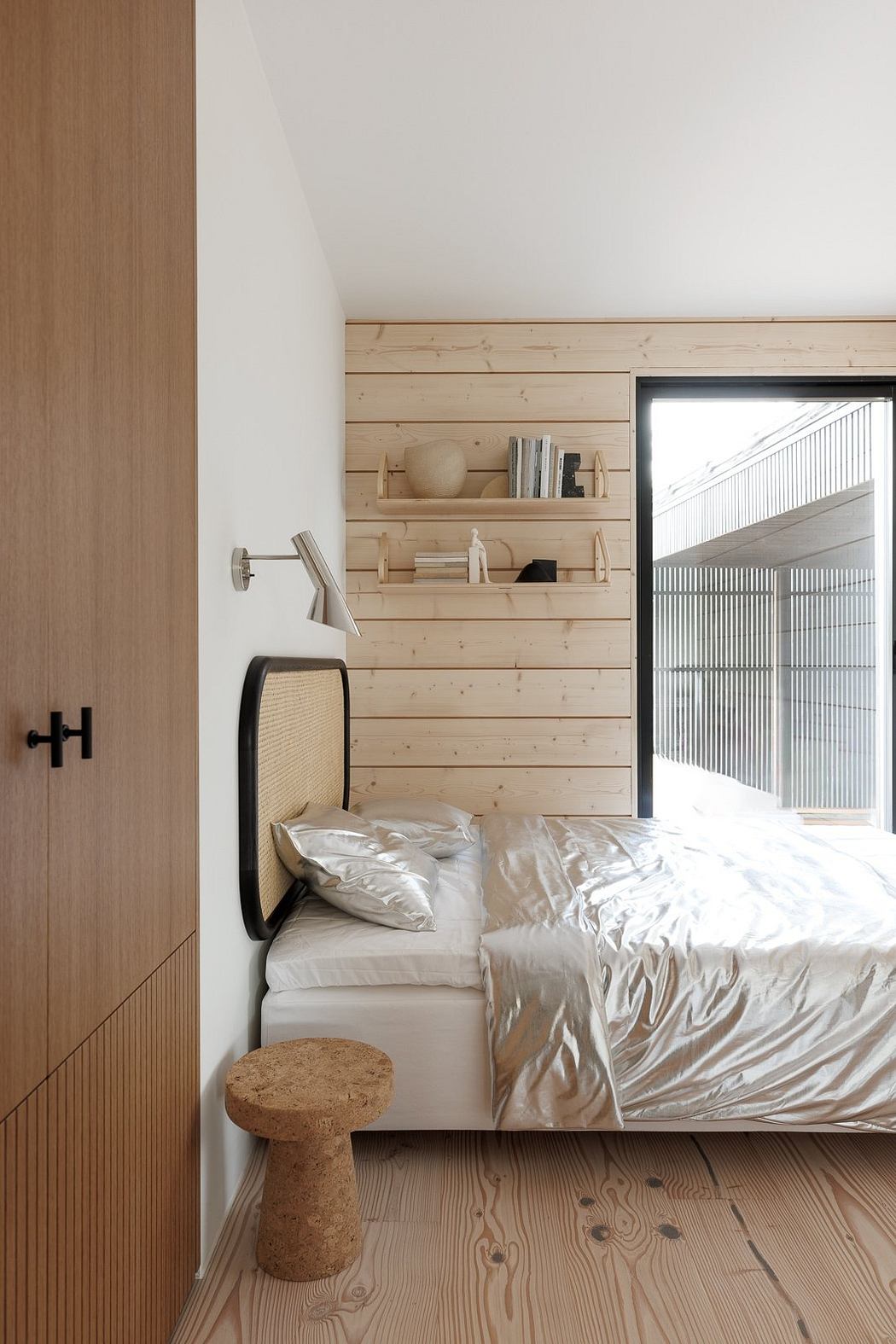 Cozy bedroom with wooden walls, shelves, and a cork stool. Minimalist design.