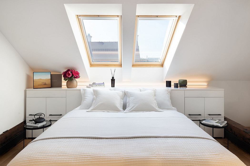 Inviting bedroom with sleek skylight windows, minimalist furniture, and decorative touches.