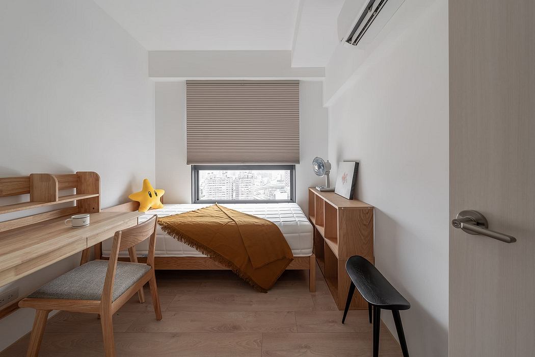 A cozy bedroom with wooden furnishings, a large window, and minimalist decor.
