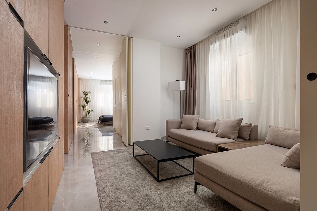 A modern, open-concept living room with minimalist furniture and sleek design elements.