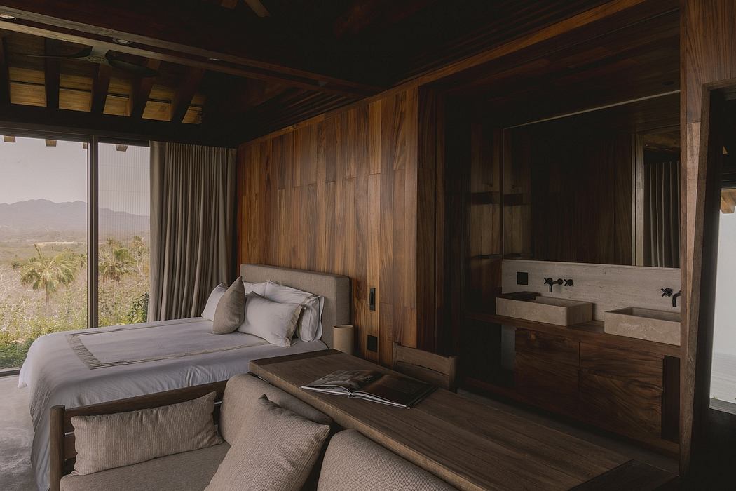 Rustic bedroom with wood-paneled walls, large windows, and modern bathroom vanity.