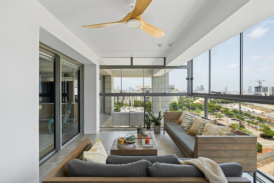 Spacious modern apartment with expansive cityscape view, sleek furniture, and wooden accents.