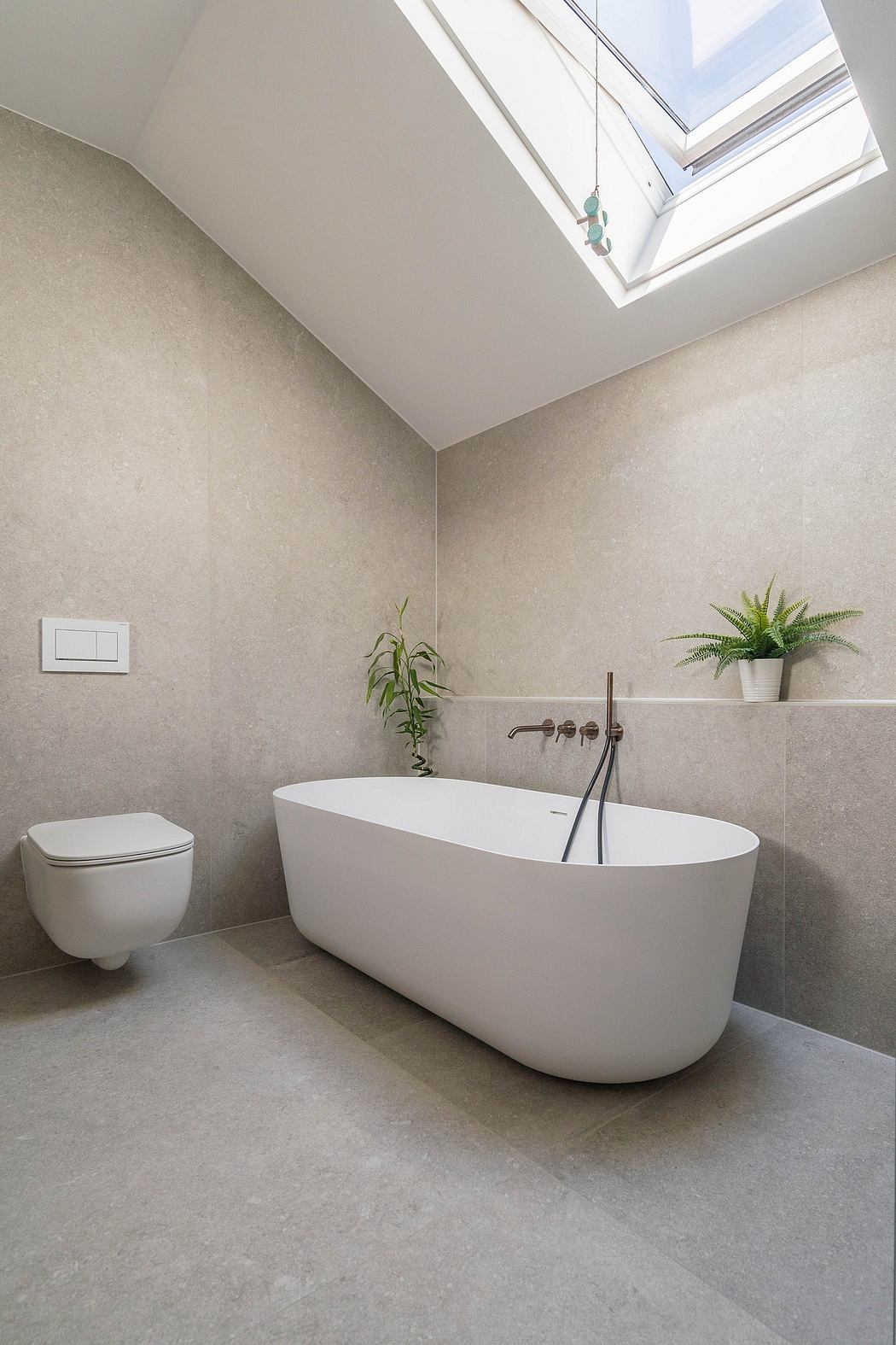 Spacious bathroom with a freestanding bathtub, floor-to-ceiling windows, and modern fixtures.