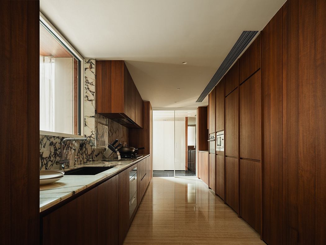 Sleek, modern kitchen with wooden cabinetry, marble countertops, and a spacious layout.