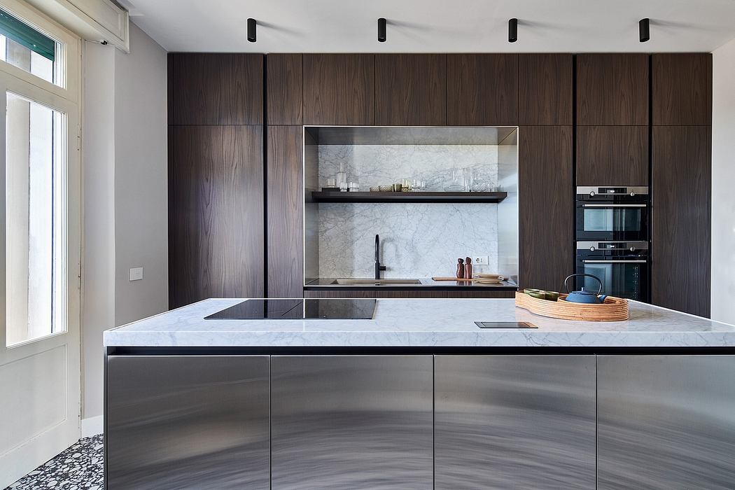 Contemporary kitchen with sleek dark wood cabinetry, white marble countertops, and built-in appliances.