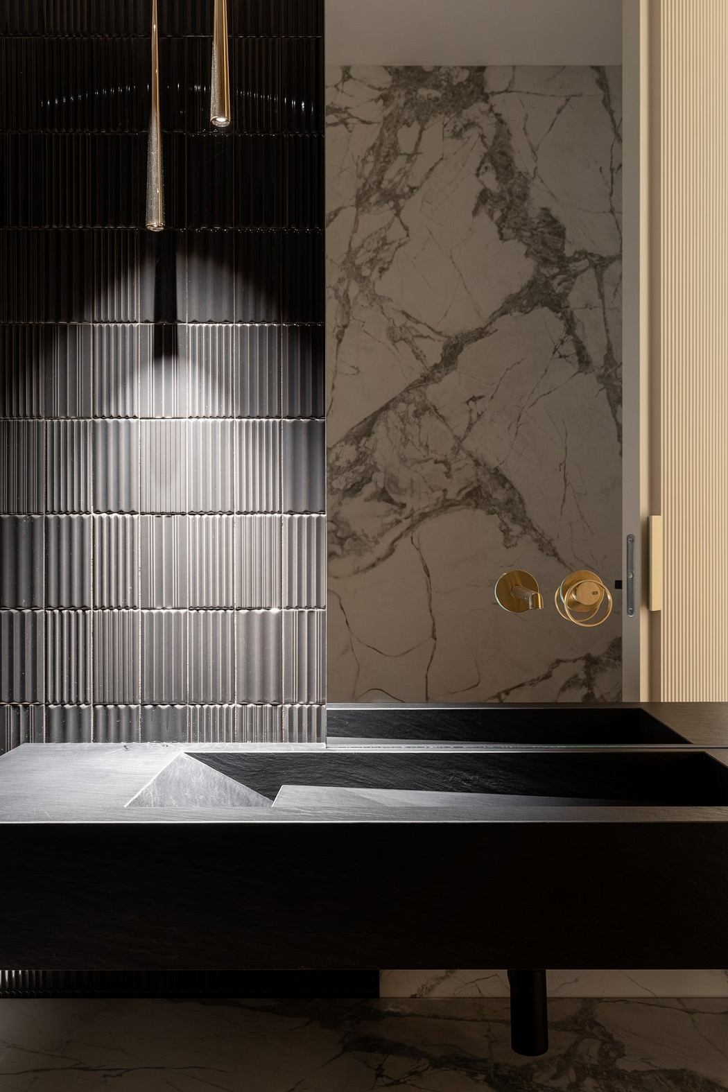 Sleek black vanity with marble-clad walls, metallic accents, and a modern shower curtain.