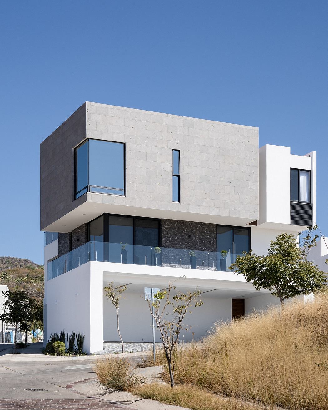 Modern, geometric building with clean lines, large windows, and contrasting materials.