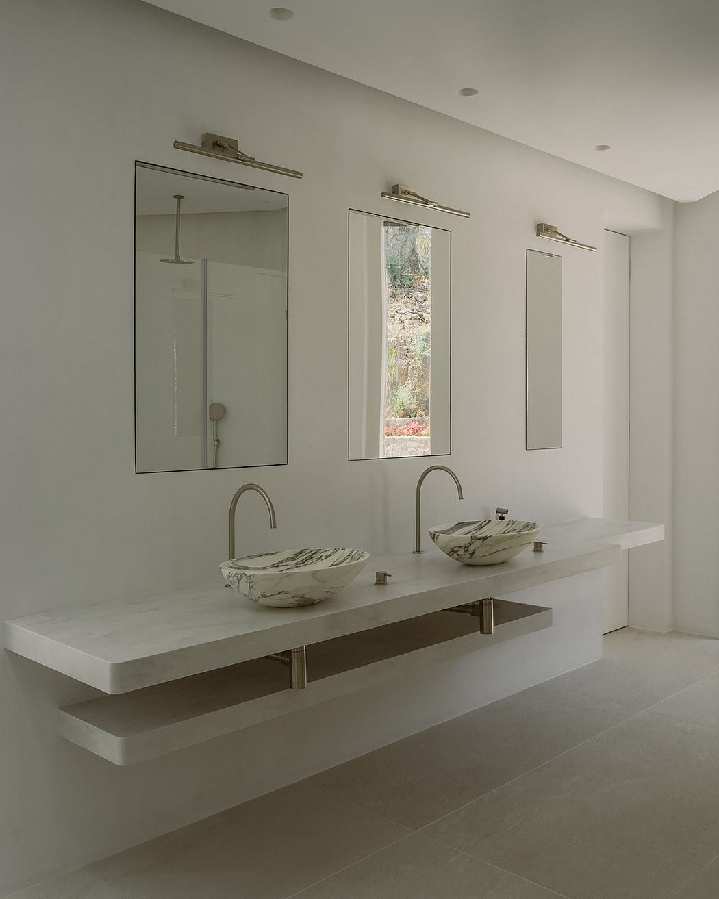 This contemporary bathroom features sleek floating vanity with vessel sinks and large mirrors.