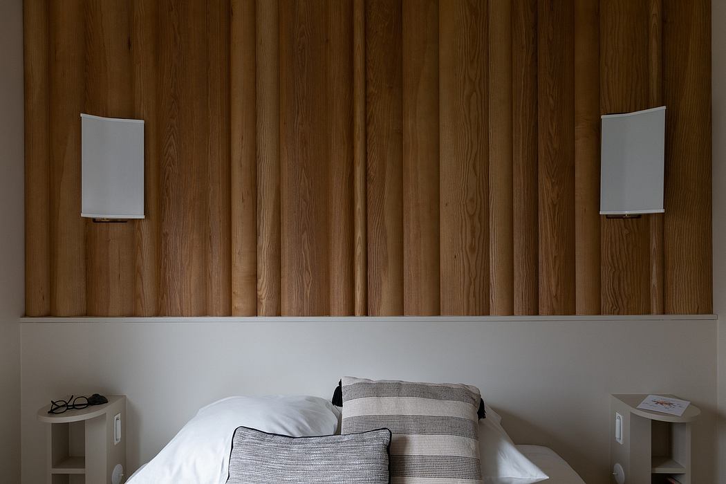 Cozy, rustic wood-paneled room with minimalist decor and stylish lighting fixtures.