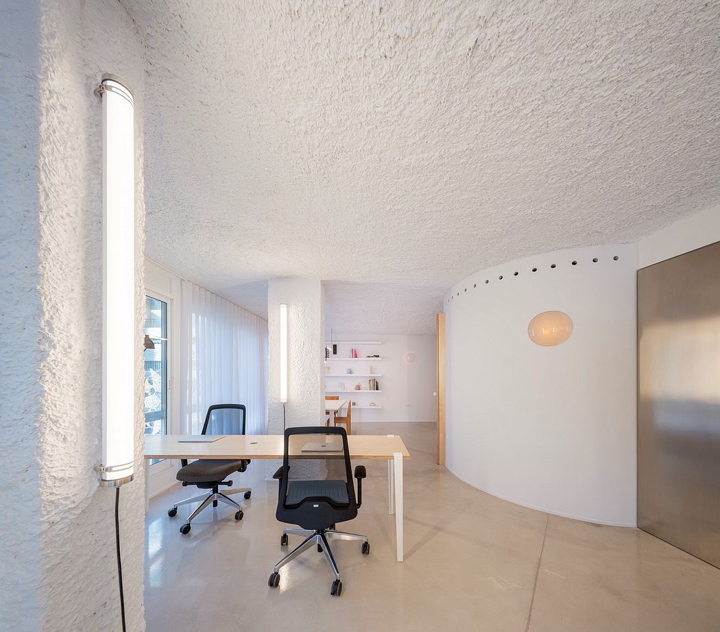 Modern, minimalist office space with a large desk, chairs, and abstract wall decor.