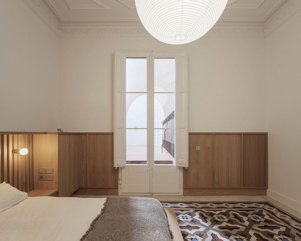 Elegant bedroom with ornate ceiling, wood paneling, and patterned rug.