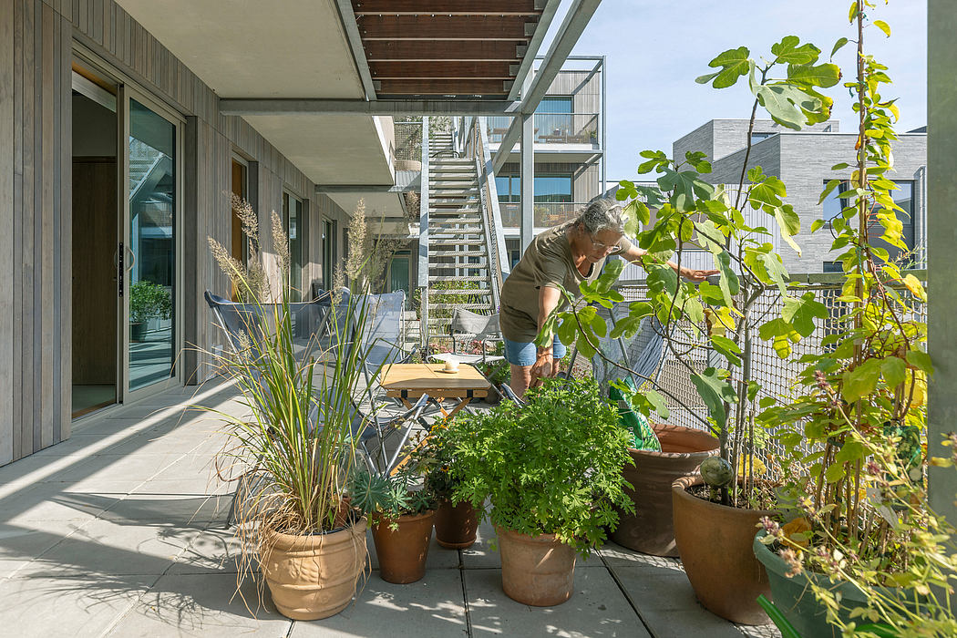 Cozy outdoor living space with potted plants, garden features, and modern architectural details.