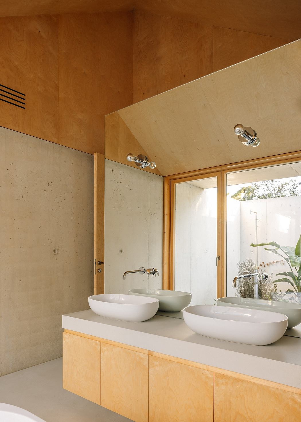 Minimalist bathroom with wooden accents, vessel sinks, and a floor-to-ceiling window.