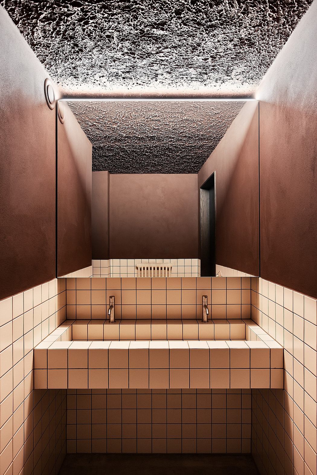 Striking geometric patterns and textures in this minimalist bathroom design.