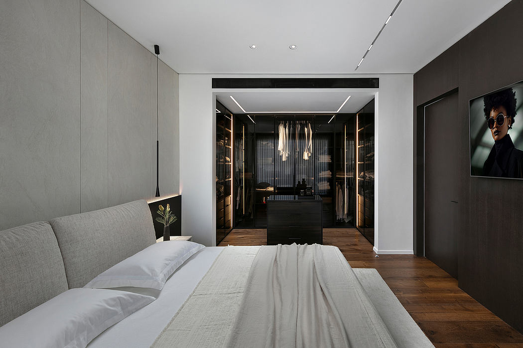 Minimalist bedroom with recessed lighting, built-in closet, and contrasting dark and light tones.