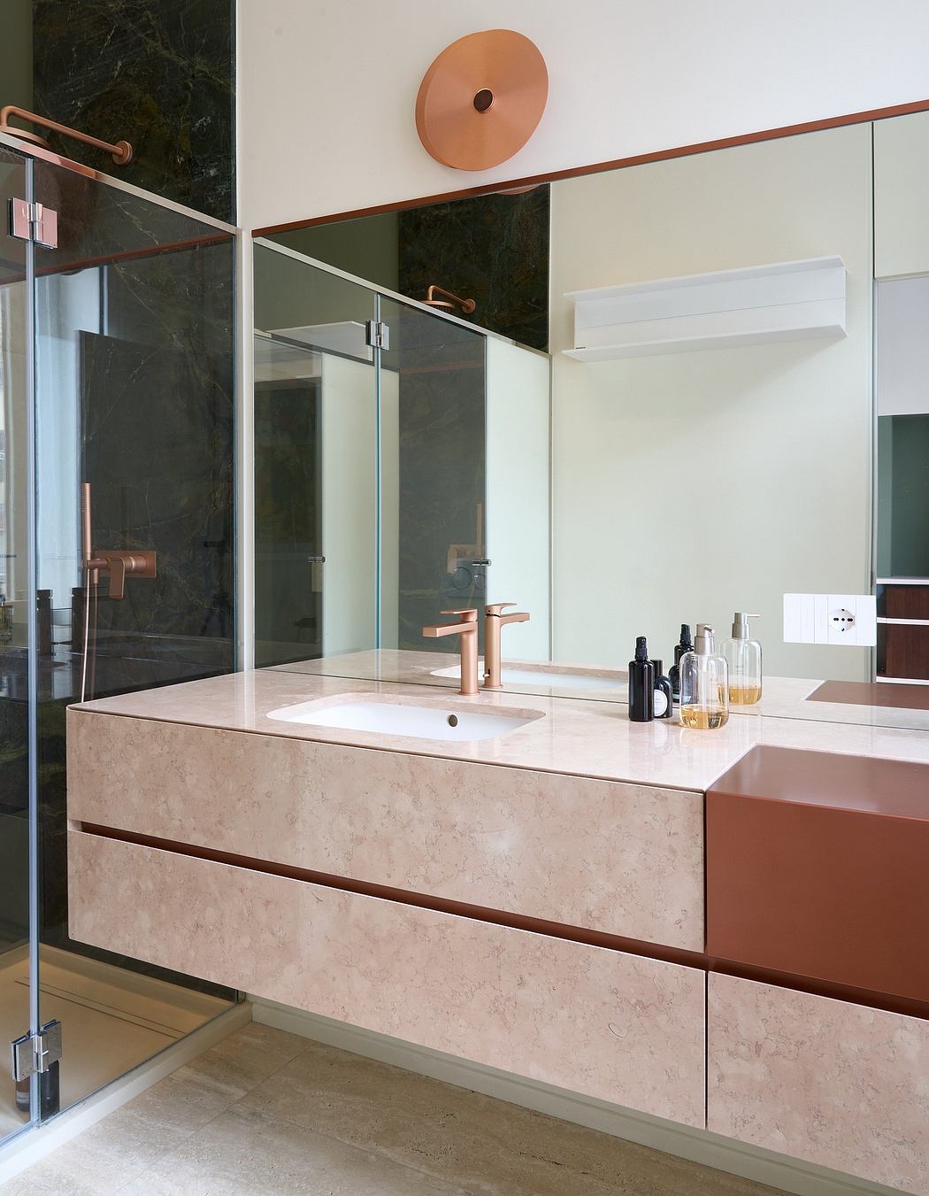 Sleek, modern bathroom with marble vanity, copper accents, and frameless glass shower.