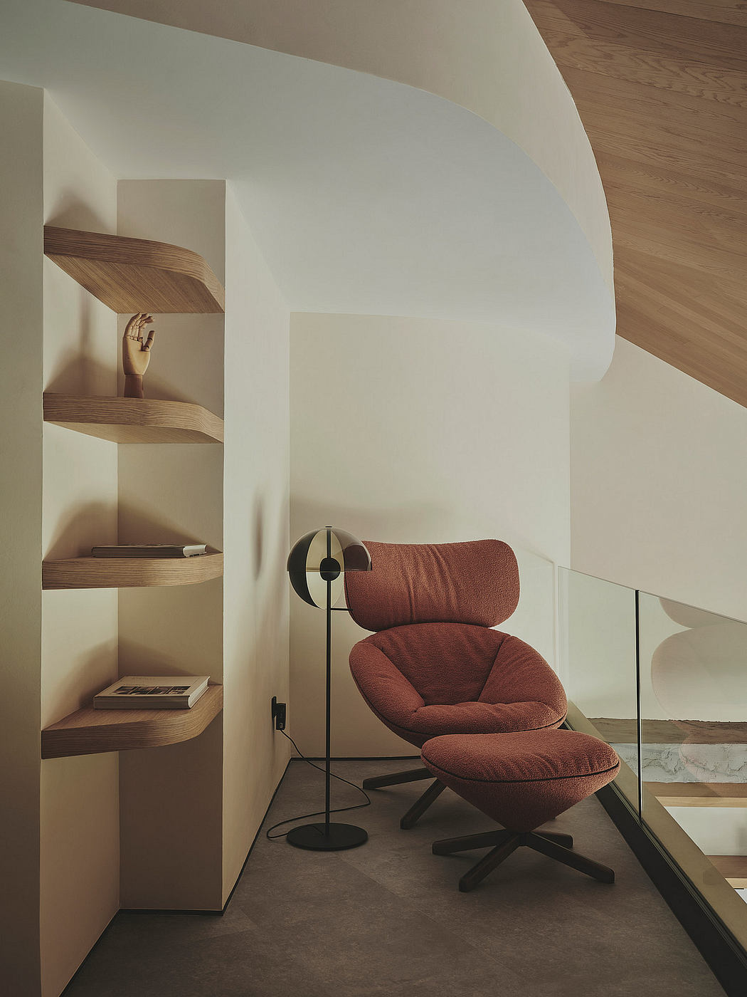 Cozy leather armchair with ottomon in minimalist, wood-accented interior.