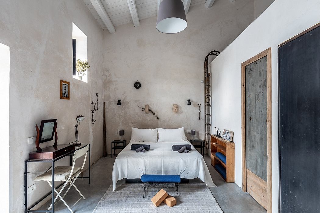 A cozy, rustic bedroom with exposed wooden beams, concrete walls, and vintage furnishings.