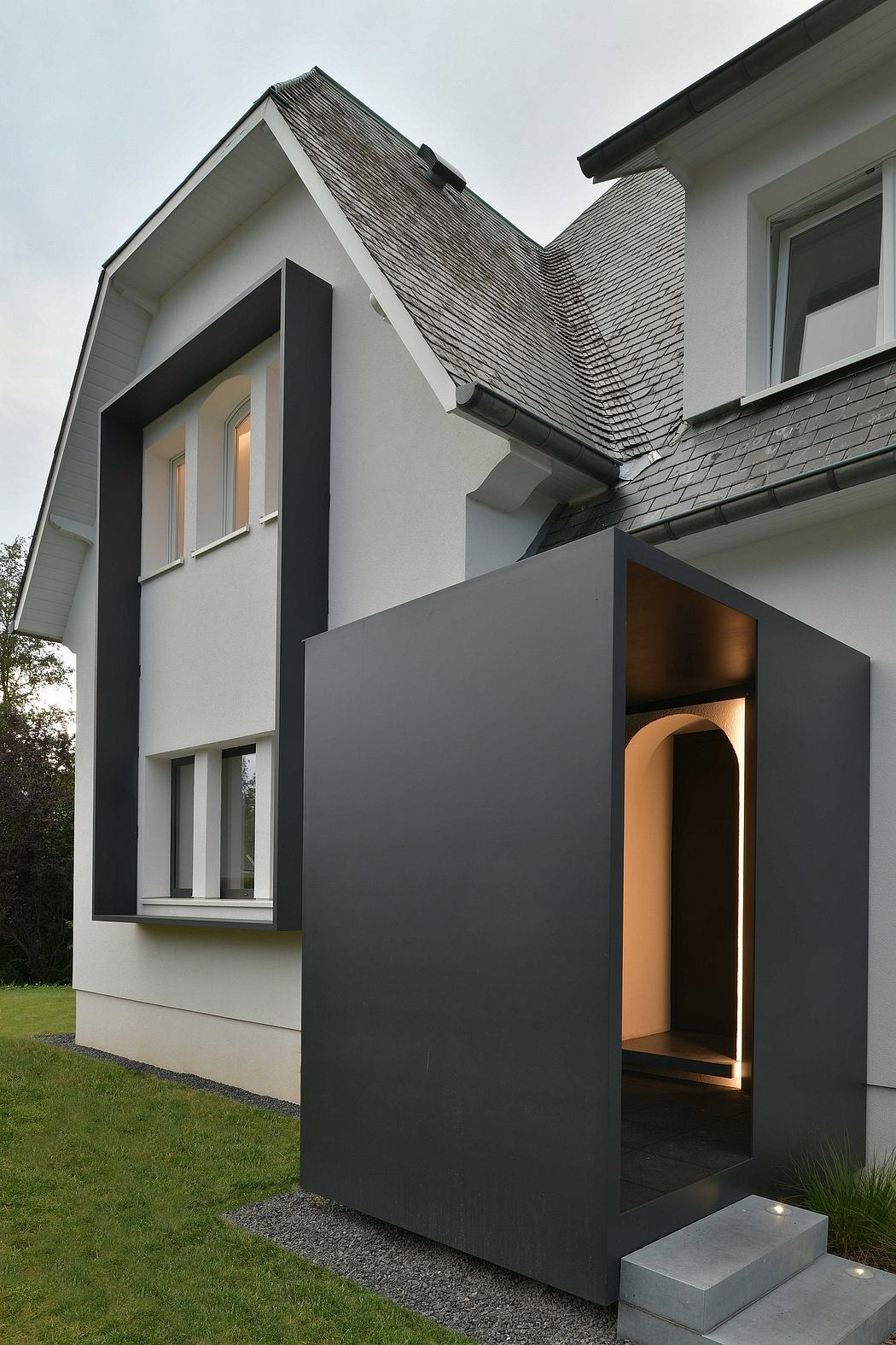 Modern house with striking black and white exterior, sleek architectural design.