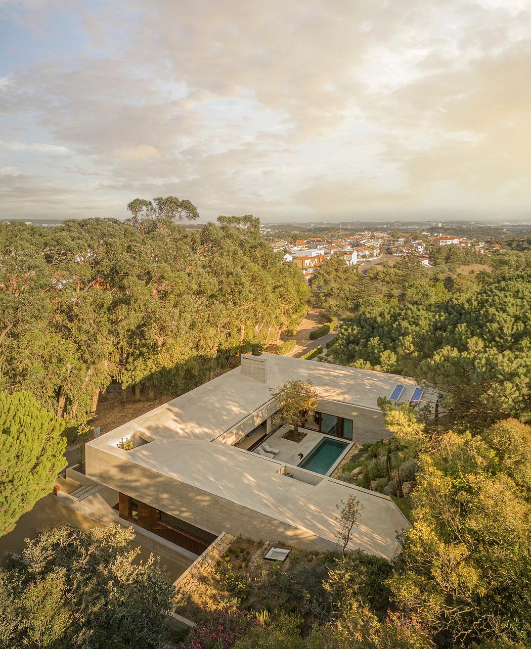 Striking modern home nestled among lush greenery, with pool and expansive views.