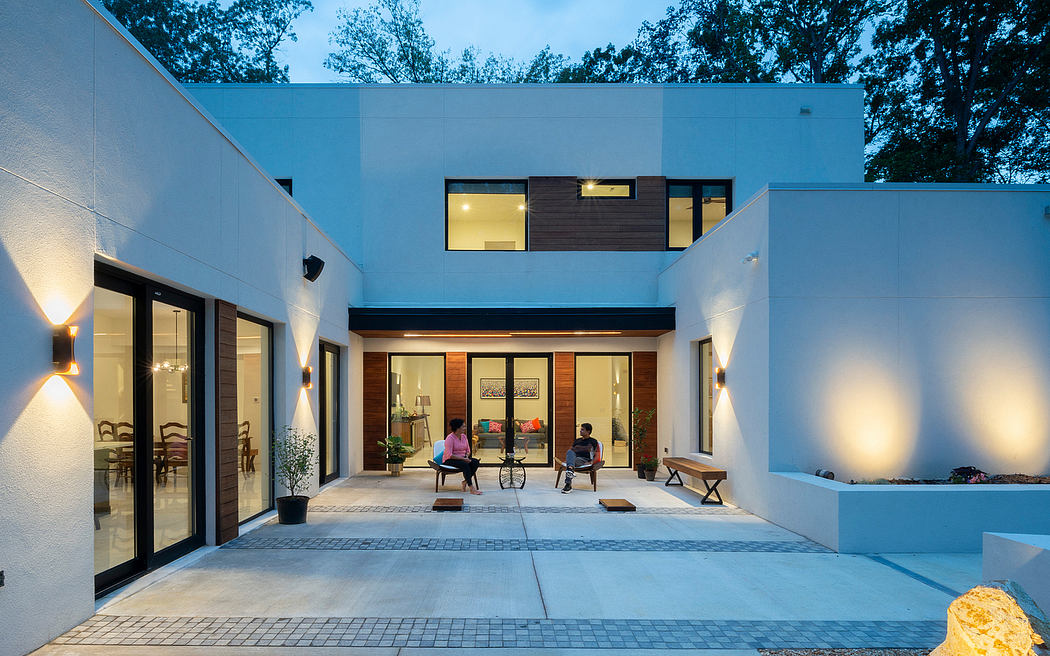 Modern, minimalist home with clean lines, warm lighting, and an inviting outdoor patio space.