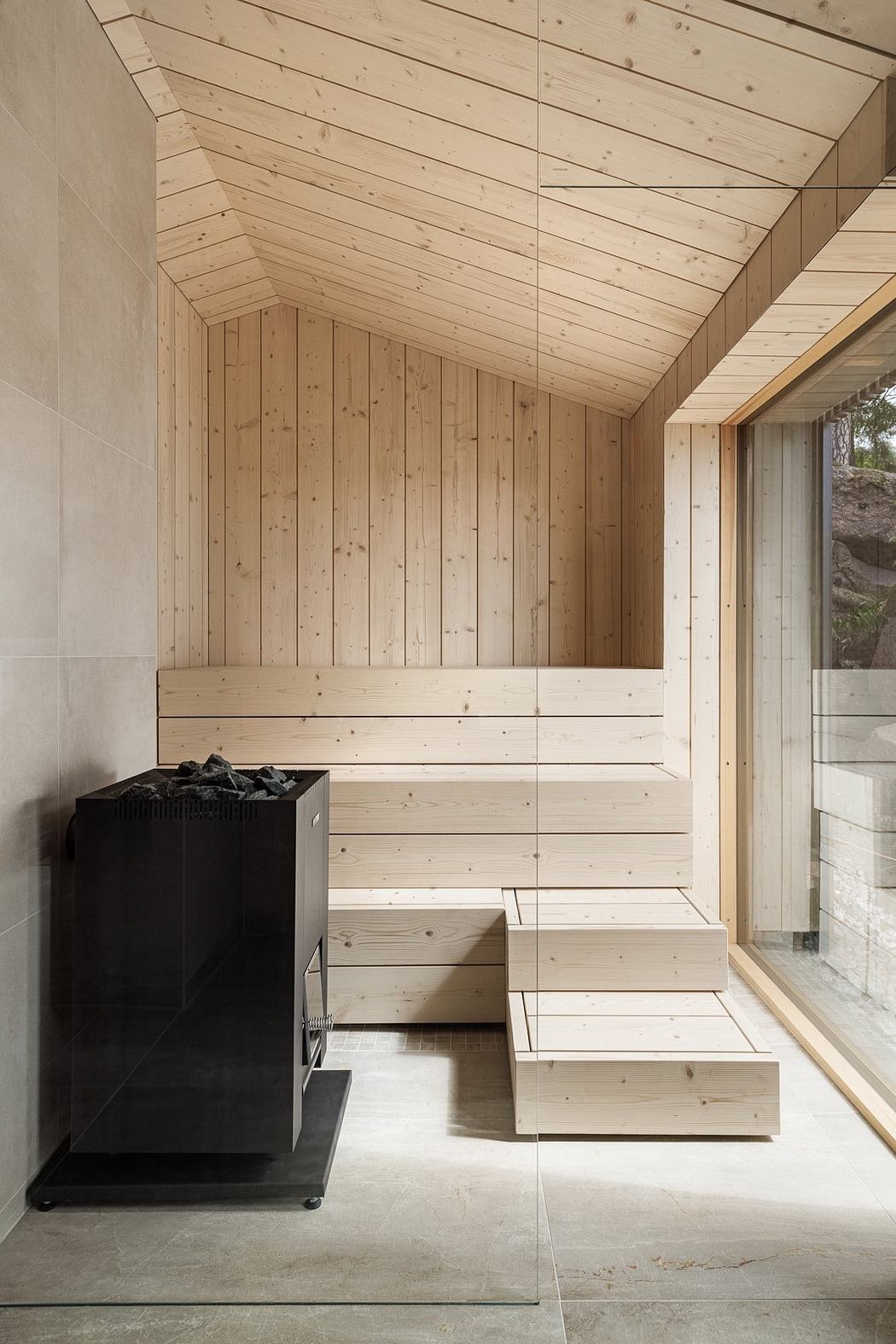 A cozy, wooden cabin interior with an electric sauna heater and built-in storage.